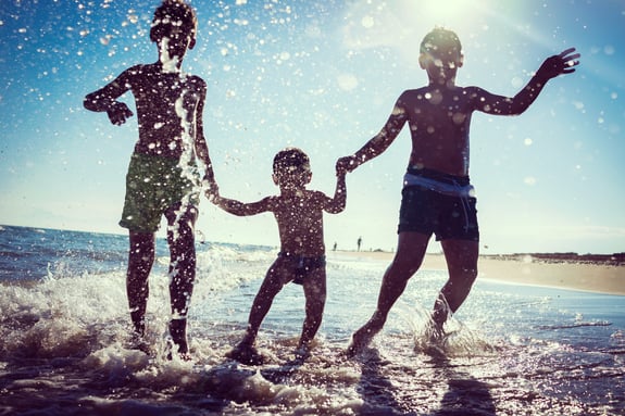 Fun kids playing splash at beach